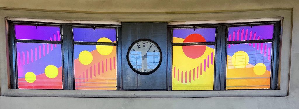 Sun blazing through window art over escalators at Southgate Station © Dan Maier